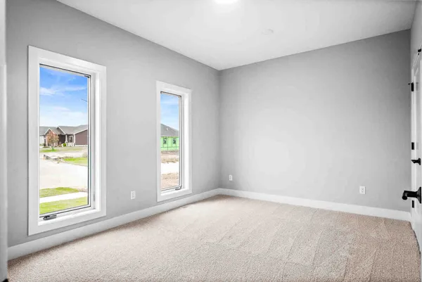 an empty room with windows and closet