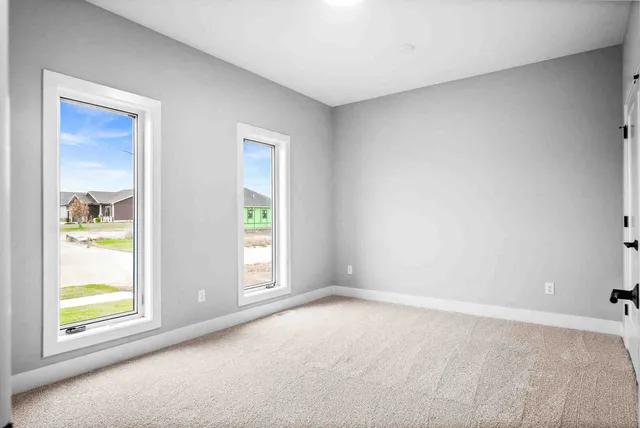 an empty room with windows and closet