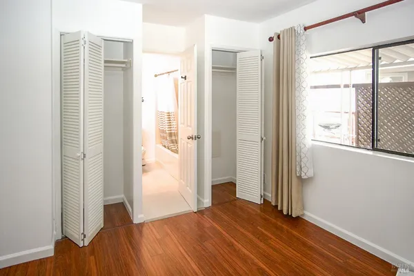 a view of hallway with wooden floor and window