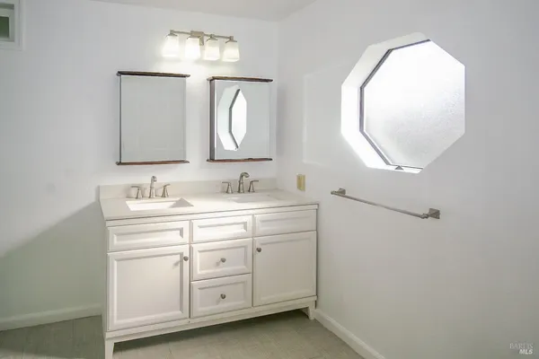 a bathroom with a sink vanity and a mirror