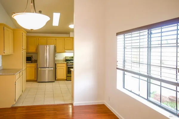 a kitchen with stainless steel appliances a refrigerator and a stove top oven