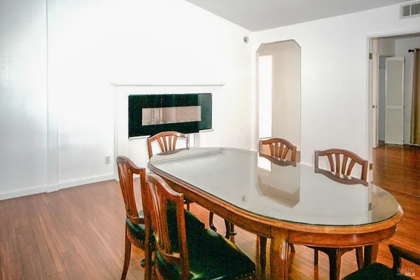 a dining room with furniture and wooden floor
