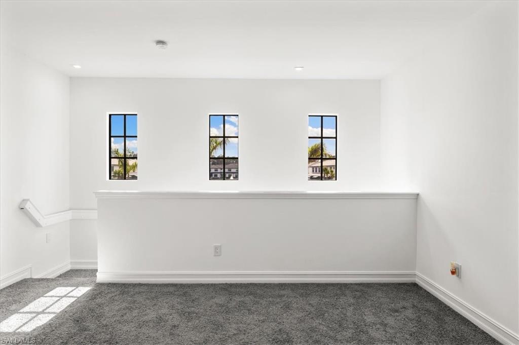 7622 Rockefeller Drive Naples, FL 34119 - Photo 15 of 40 an empty room with windows