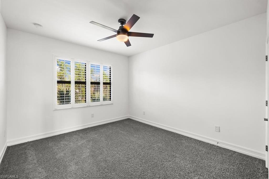 7622 Rockefeller Drive Naples, FL 34119 - Photo 18 of 40 an empty room with windows and fan