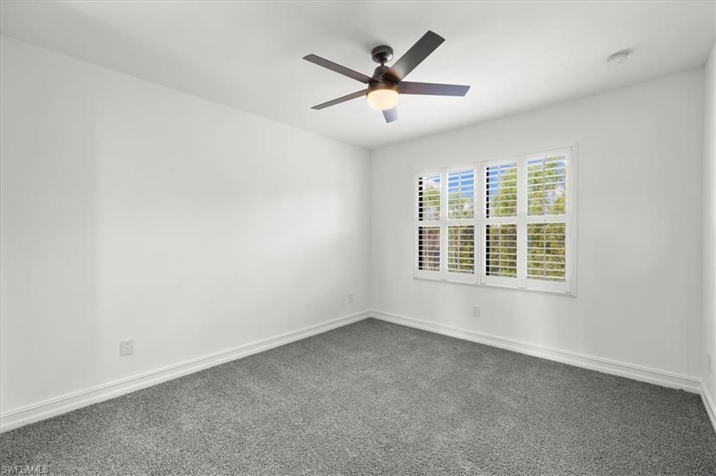 7622 Rockefeller Drive Naples, FL 34119 - Photo 20 of 40 an empty room with ceiling fan and windows