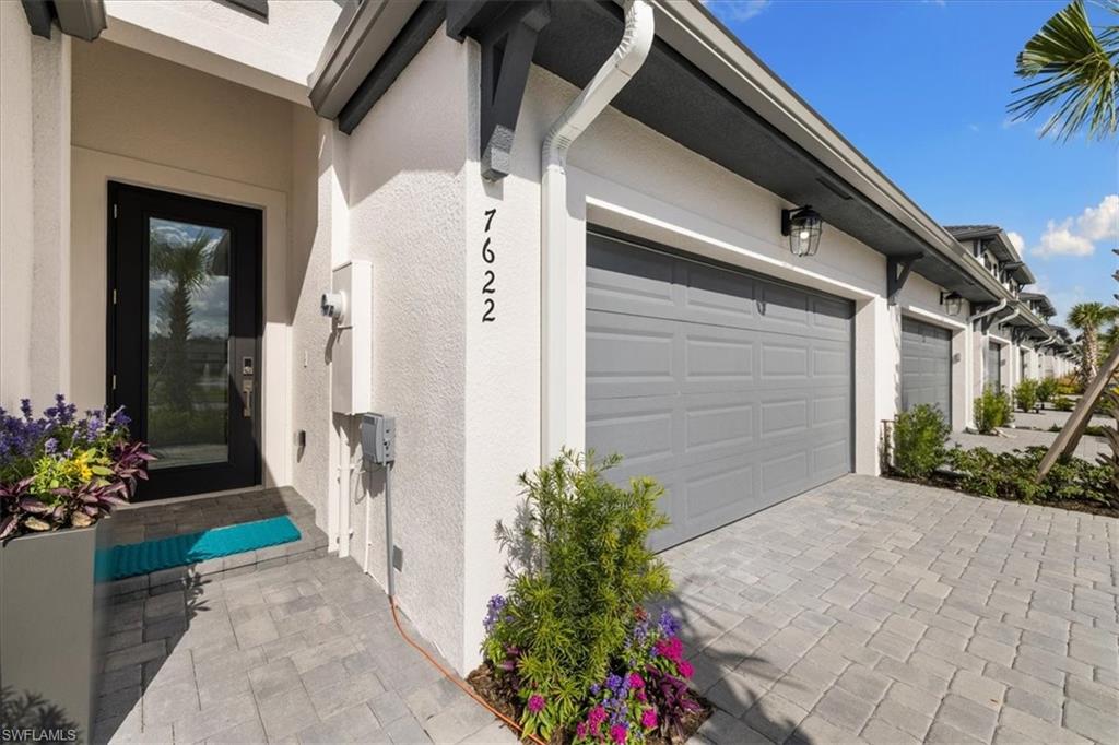 7622 Rockefeller Drive Naples, FL 34119 - Photo 2 of 40 a front view of a house with a yard