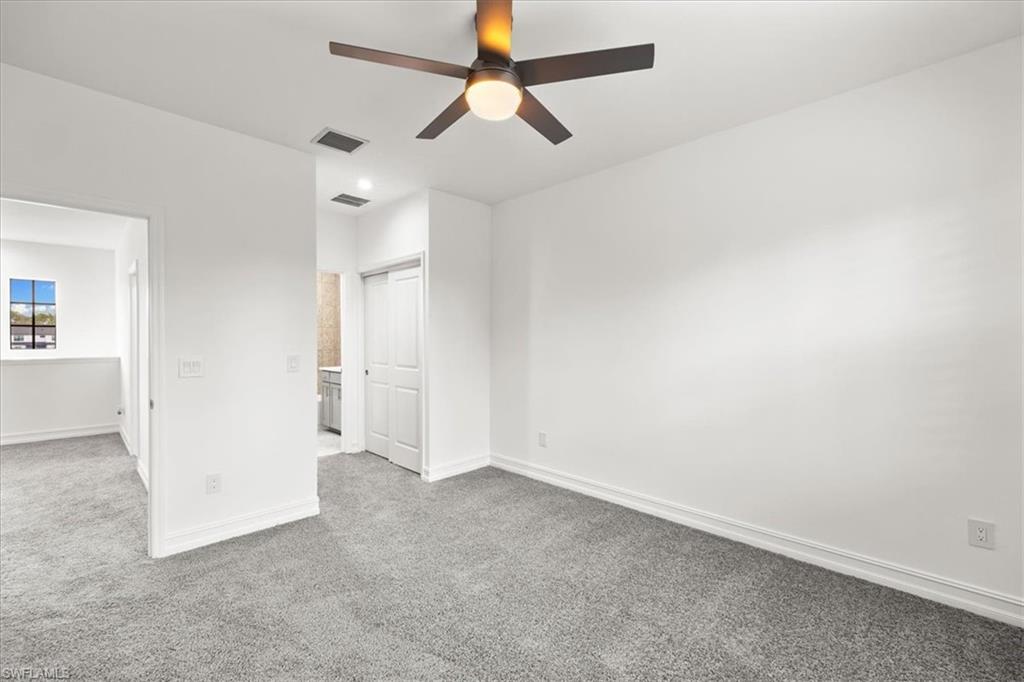7622 Rockefeller Drive Naples, FL 34119 - Photo 21 of 40 an empty room with a ceiling fan and a window