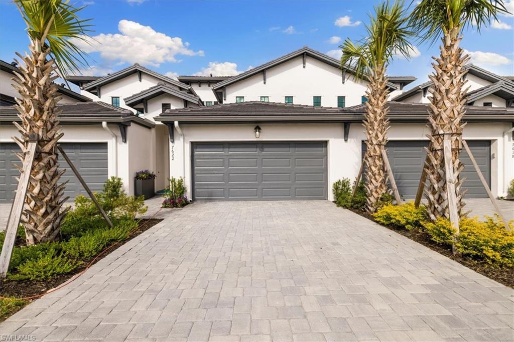 7622 Rockefeller Drive Naples, FL 34119 - Photo 3 of 40 a front view of a house with a yard and garage