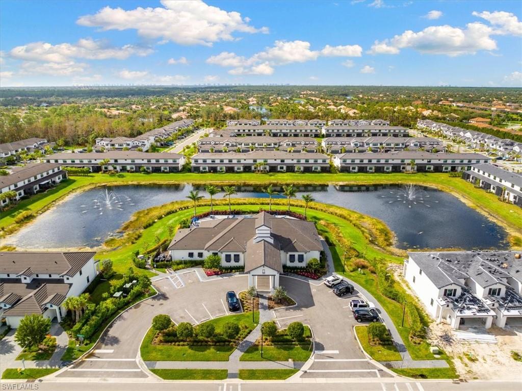 7622 Rockefeller Drive Naples, FL 34119 - Photo 39 of 40 a view of a swimming pool with a table and chairs