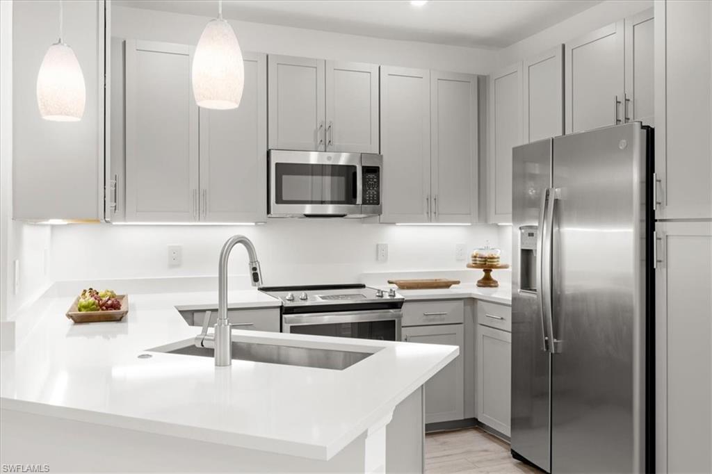 7622 Rockefeller Drive Naples, FL 34119 - Photo 6 of 40 a kitchen with a refrigerator sink and microwave