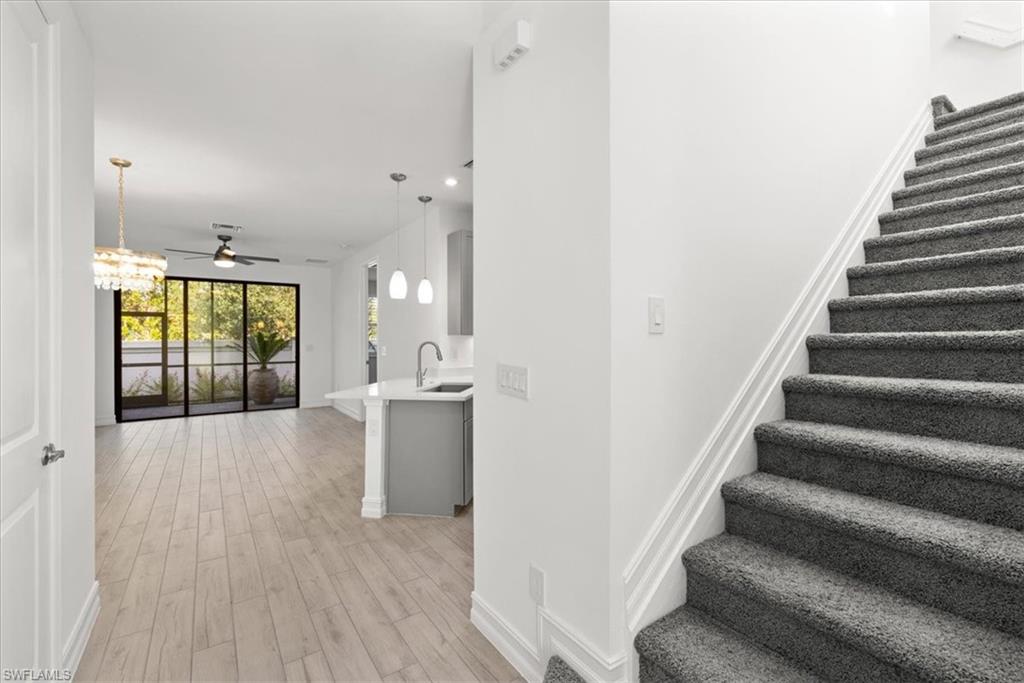 7622 Rockefeller Drive Naples, FL 34119 - Photo 8 of 40 a view of an entryway with wooden floor and windows
