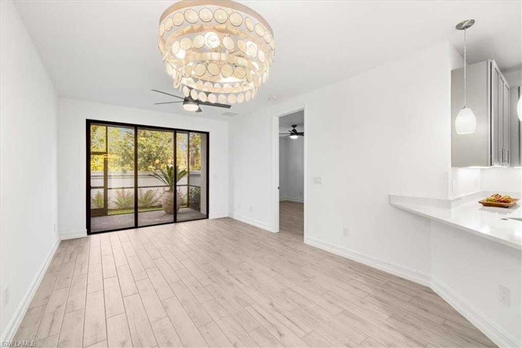 7622 Rockefeller Drive Naples, FL 34119 - Photo 10 of 40 a view of livingroom with furniture wooden floor and chandelier
