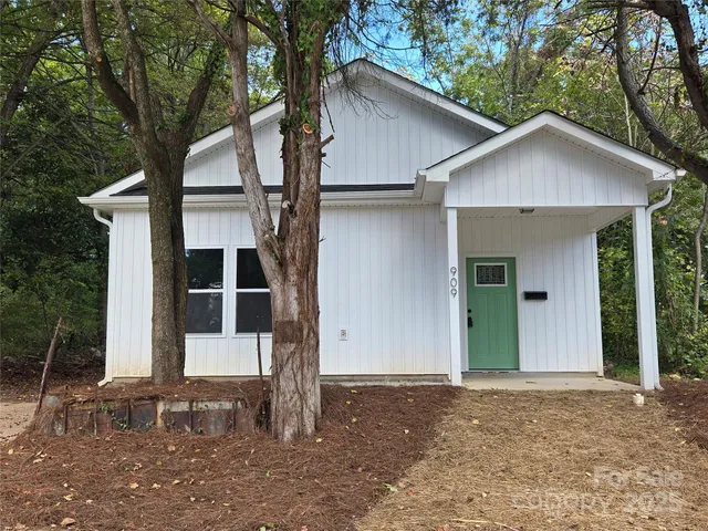 a view of a house with a yard and garage
