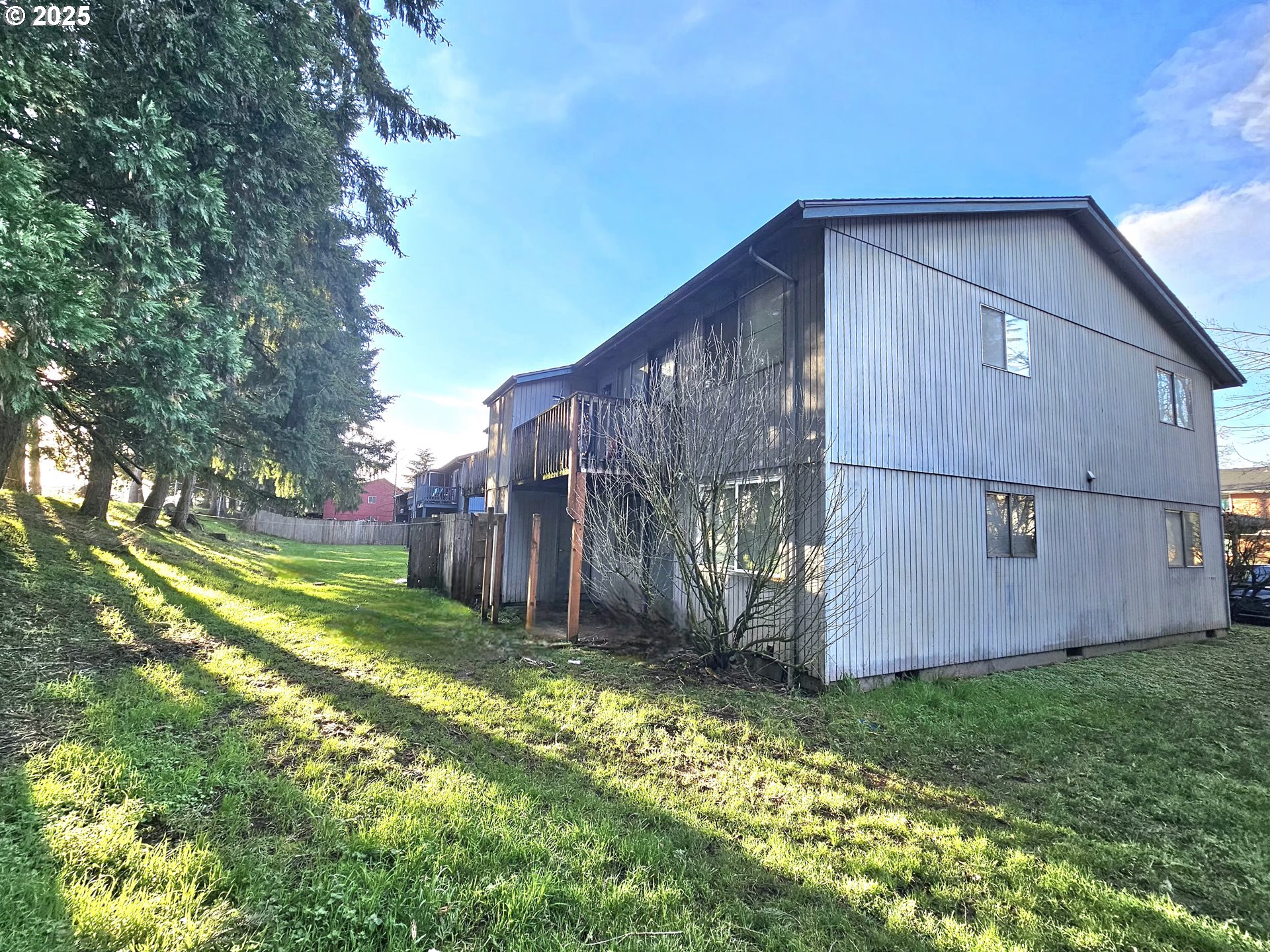 5495 South A Street Springfield, OR 97478 - Photo 2 of 10 a view of a backyard with potted plants and large tree