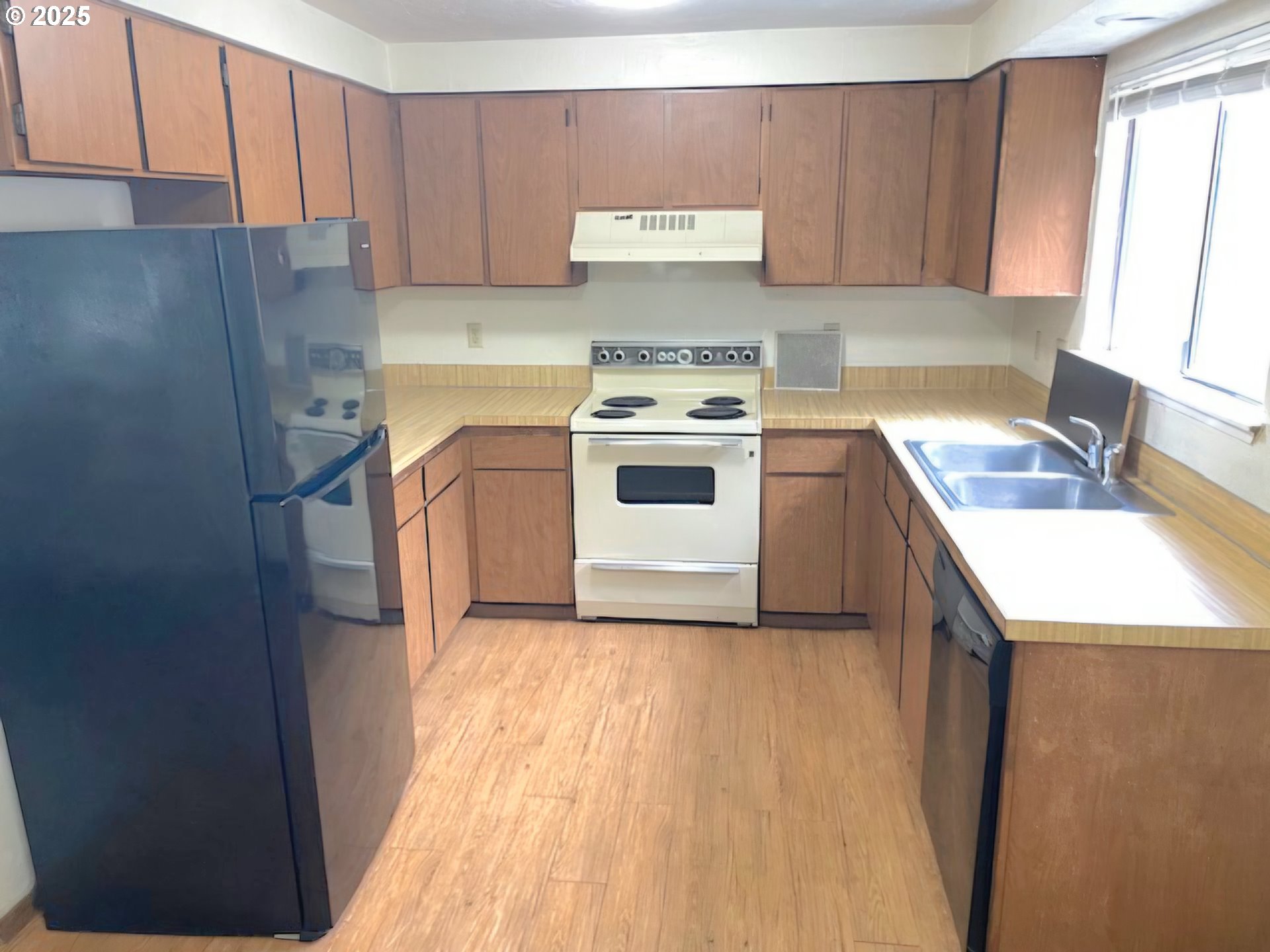 5495 South A Street Springfield, OR 97478 - Photo 4 of 10 a kitchen with a white cabinets and white appliances