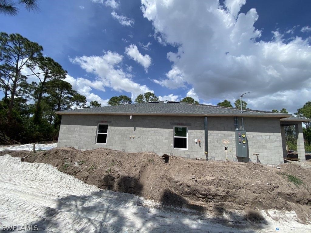 833-835 Meadow Road Lehigh Acres, FL 33973 - Photo 4 of 6 a front view of a house with a yard and garage