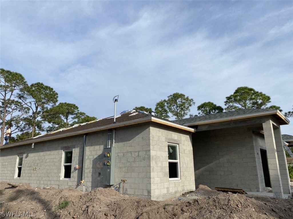 833-835 Meadow Road Lehigh Acres, FL 33973 - Photo 5 of 6 a front view of a house with a yard