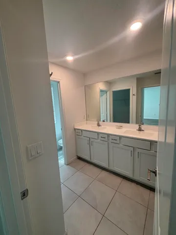 a bathroom with a double vanity sink and mirror