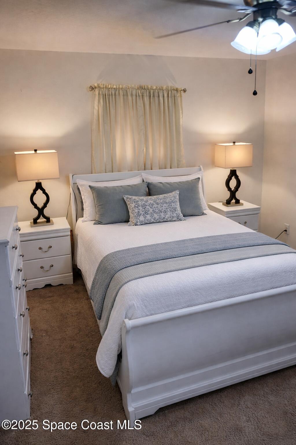 645 Chicago Way Dundee, FL 33838 - Photo 14 of 25 a bedroom with a bed and a chandelier