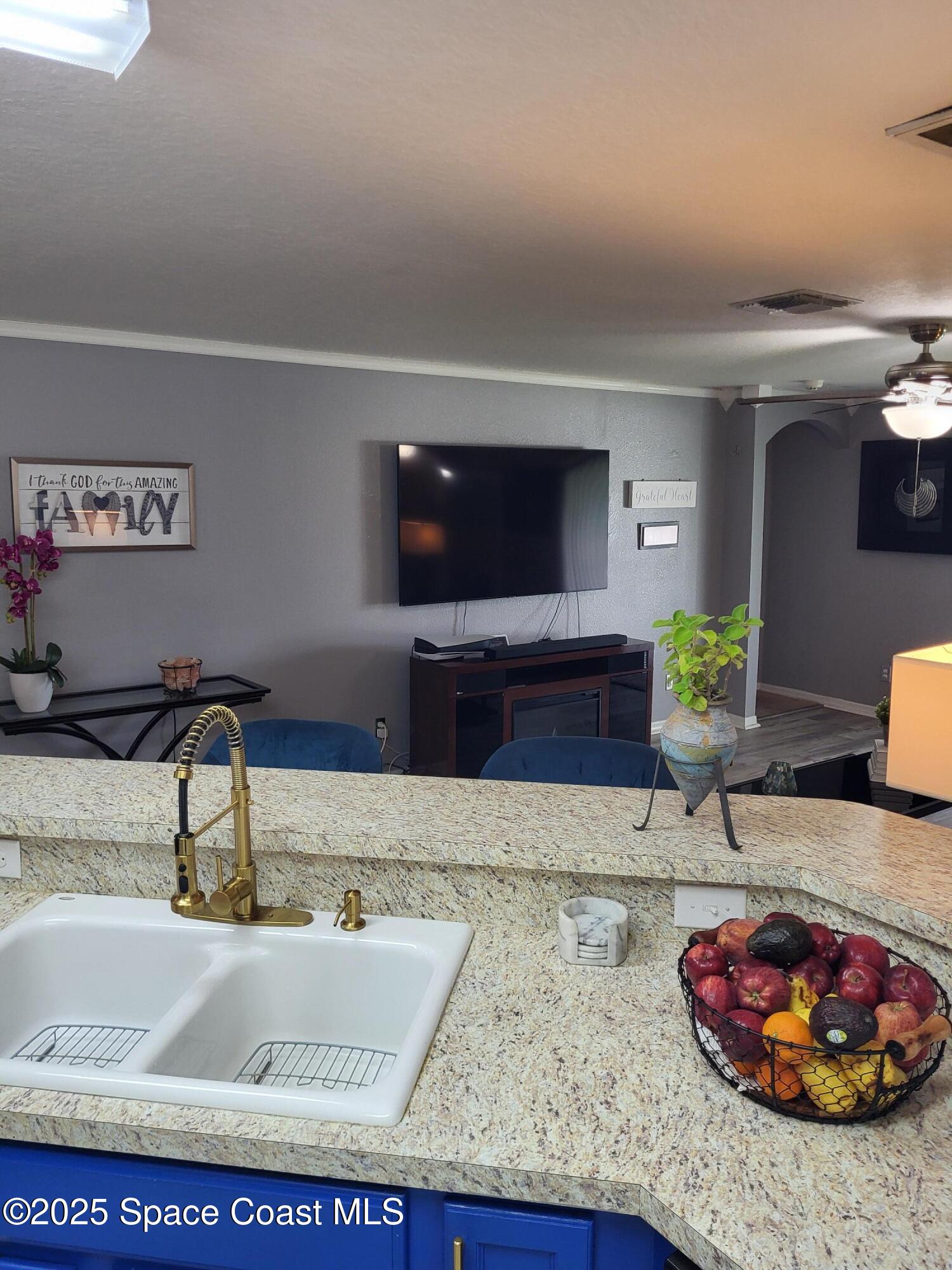 645 Chicago Way Dundee, FL 33838 - Photo 6 of 25 a living room with furniture and a flat screen tv
