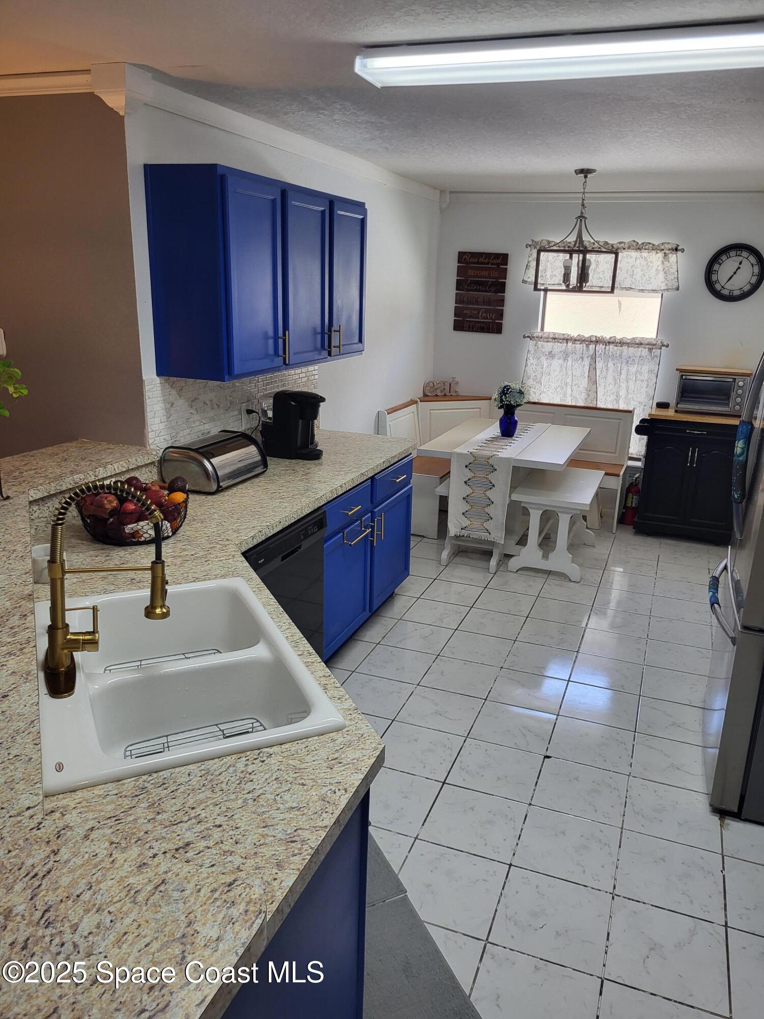 645 Chicago Way Dundee, FL 33838 - Photo 7 of 25 a kitchen with a sink a stove and cabinets
