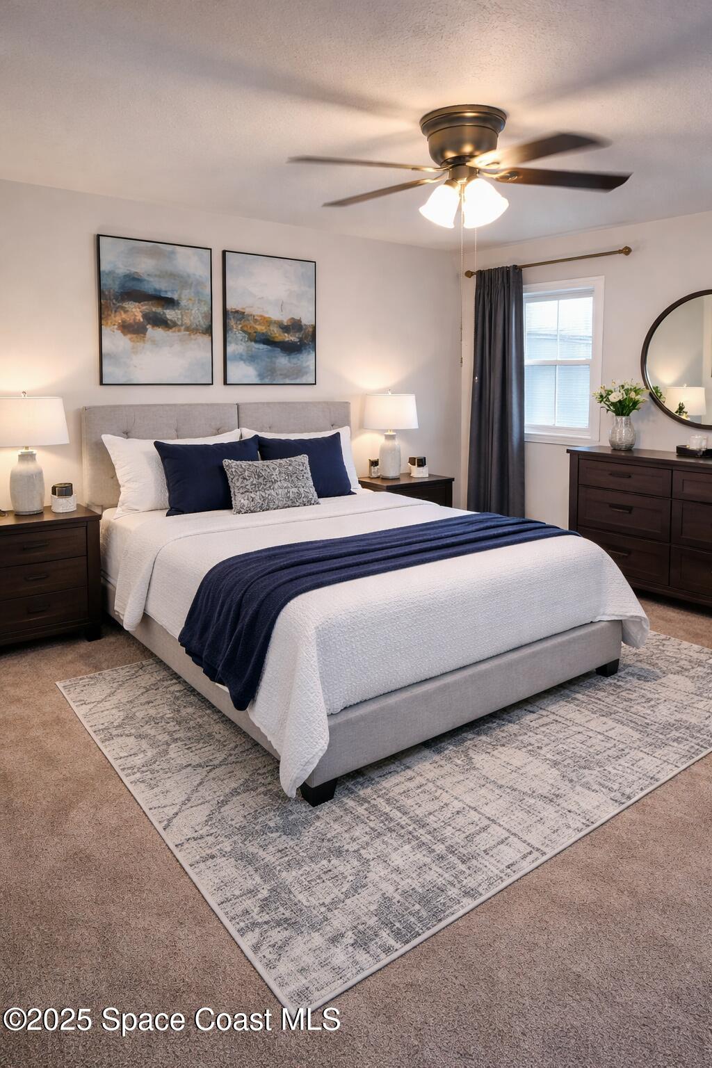 645 Chicago Way Dundee, FL 33838 - Photo 9 of 25 a bedroom with a large bed and a chandelier