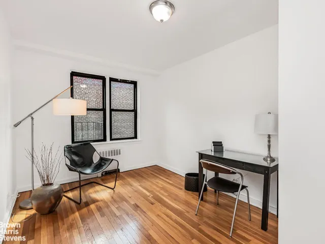 a spacious bedroom with a bed and a flat screen tv