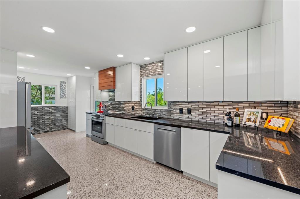 2014 Riverside Drive East Bradenton, FL 34208 - Photo 30 of 66 a kitchen with stainless steel appliances granite countertop a sink stove and refrigerator