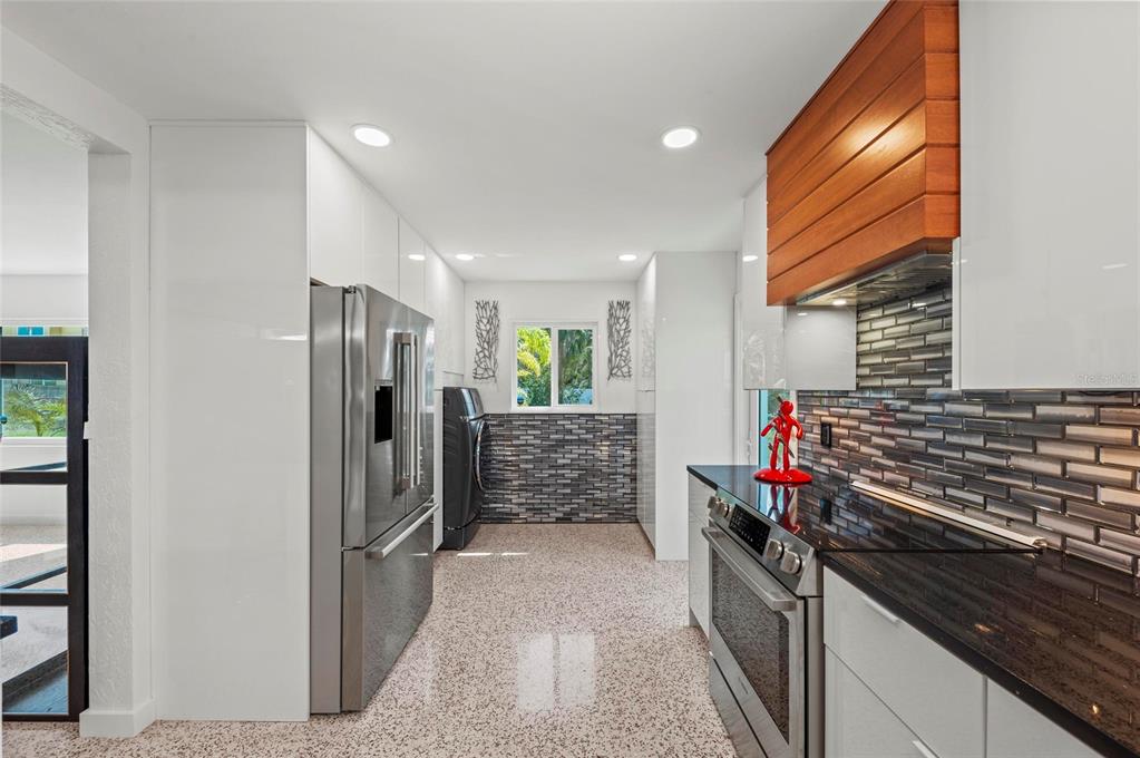 2014 Riverside Drive East Bradenton, FL 34208 - Photo 33 of 66 a kitchen with stainless steel appliances granite countertop a refrigerator and a stove