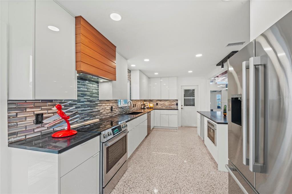 2014 Riverside Drive East Bradenton, FL 34208 - Photo 34 of 66 a kitchen with stainless steel appliances granite countertop a refrigerator and a stove