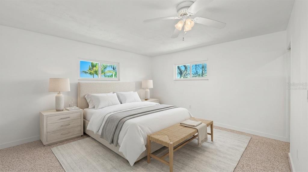2014 Riverside Drive East Bradenton, FL 34208 - Photo 36 of 66 a bedroom with a bed and a chandelier