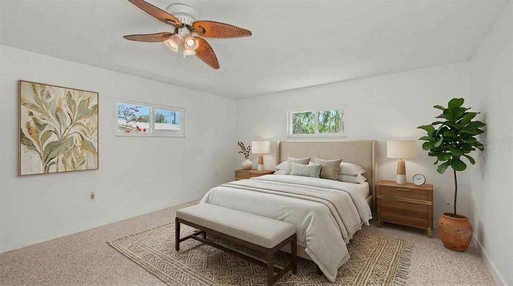 2014 Riverside Drive East Bradenton, FL 34208 - Photo 41 of 66 a bedroom with a bed and a potted plant