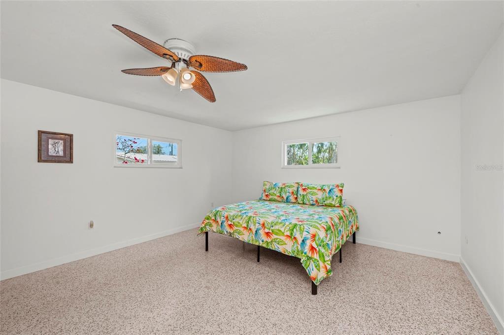 2014 Riverside Drive East Bradenton, FL 34208 - Photo 42 of 66 a bedroom with a bed and a chandelier