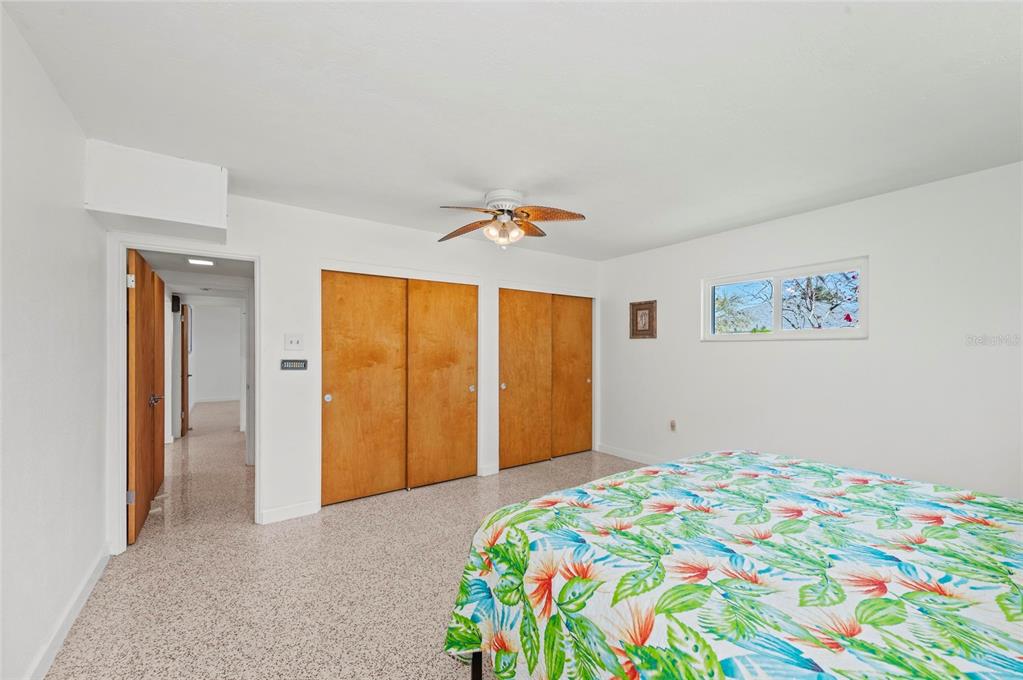 2014 Riverside Drive East Bradenton, FL 34208 - Photo 43 of 66 a bedroom with a bed and a painting on the wall