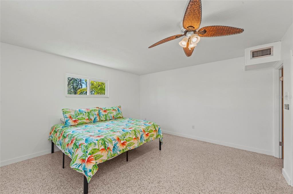 2014 Riverside Drive East Bradenton, FL 34208 - Photo 44 of 66 a bedroom with a bed a window and dresser