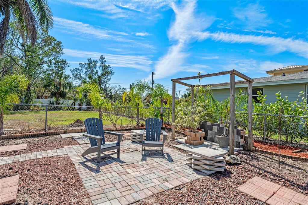 2014 Riverside Drive East Bradenton, FL 34208 - Photo 51 of 66 a view of a patio with a table and chairs under an umbrella