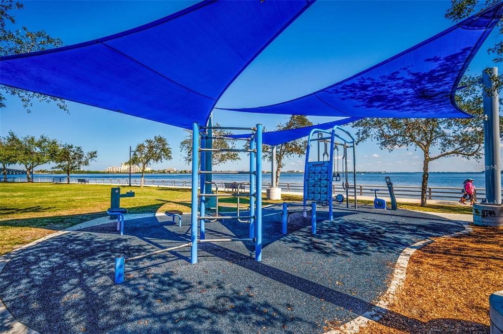 2014 Riverside Drive East Bradenton, FL 34208 - Photo 60 of 66 a view of a swimming pool with a table and chairs under an umbrella