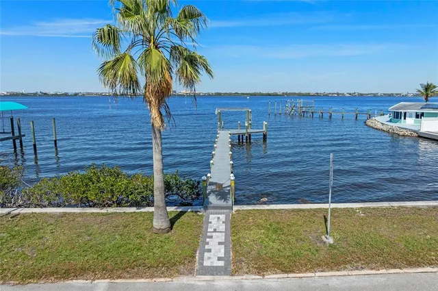 a living room with lots of furniture and kitchen view