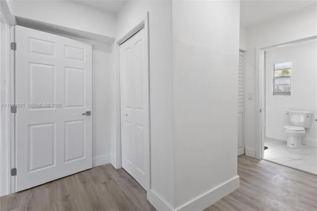 a view of a bathroom with wooden floor