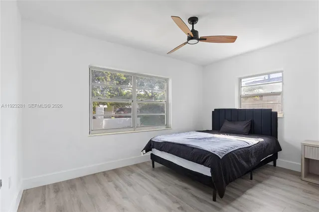 a bedroom with a bed and window