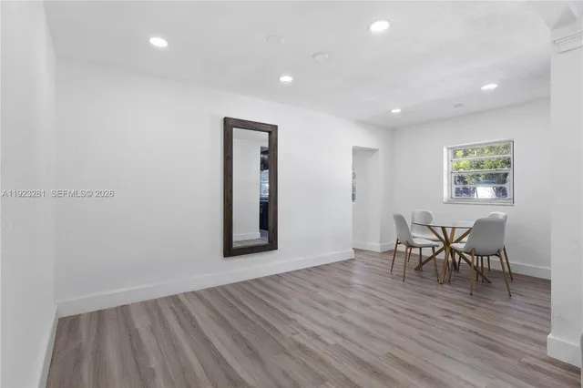 a view of a room with furniture and wooden floor