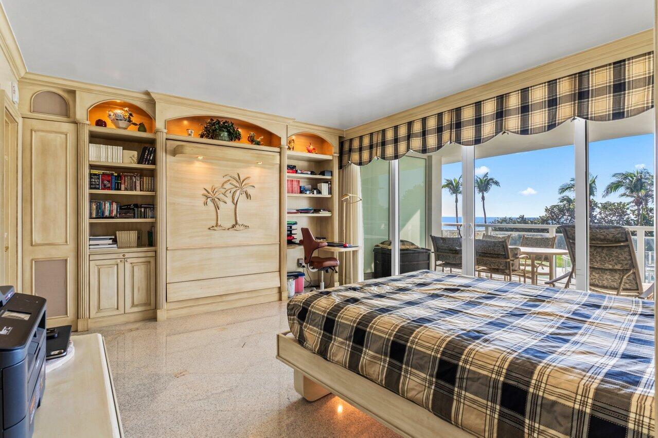 1213 South Ocean Boulevard, Unit 2B Delray Beach, FL 33483 - Photo 25 of 43 a bed sitting in a bedroom next to a window