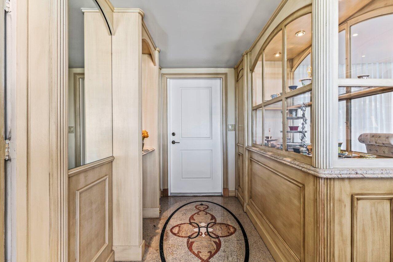 1213 South Ocean Boulevard, Unit 2B Delray Beach, FL 33483 - Photo 5 of 43 a view of a hallway with wooden cabinets and entryway