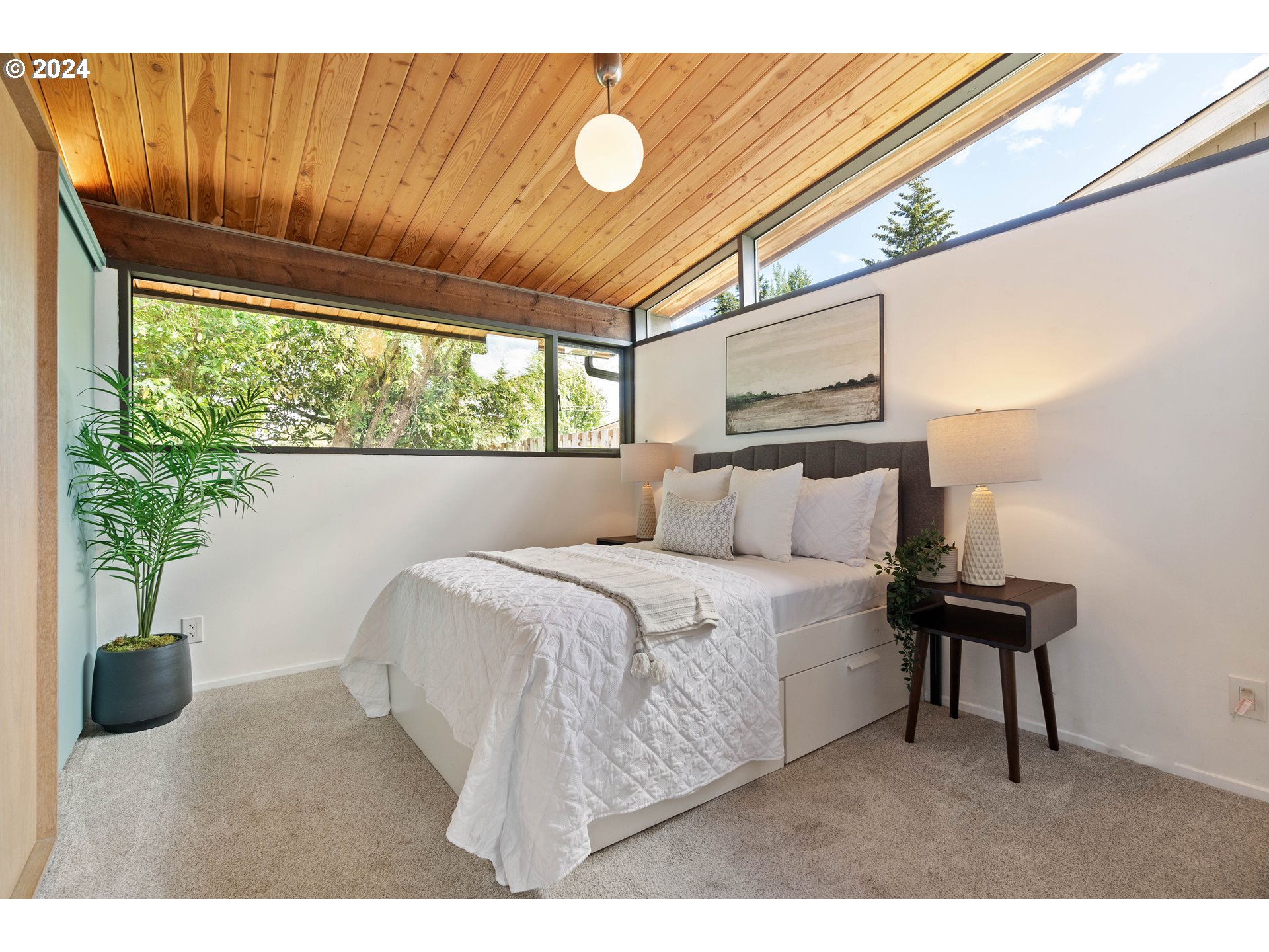 12325 Southwest Park Way Portland, OR 97225 - Photo 17 of 40 a bedroom with a bed and a potted plant