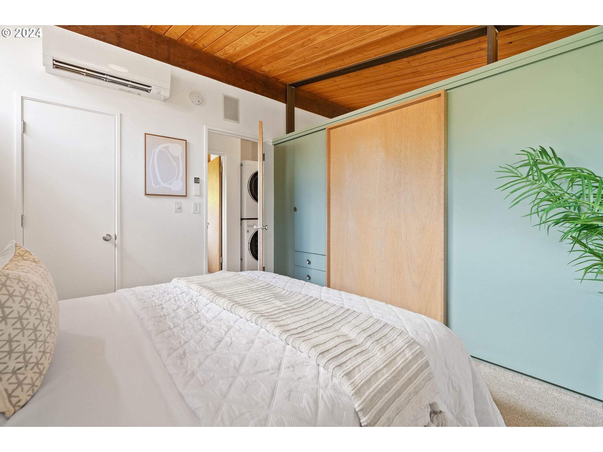 12325 Southwest Park Way Portland, OR 97225 - Photo 19 of 40 a bedroom with a bed and a potted plant