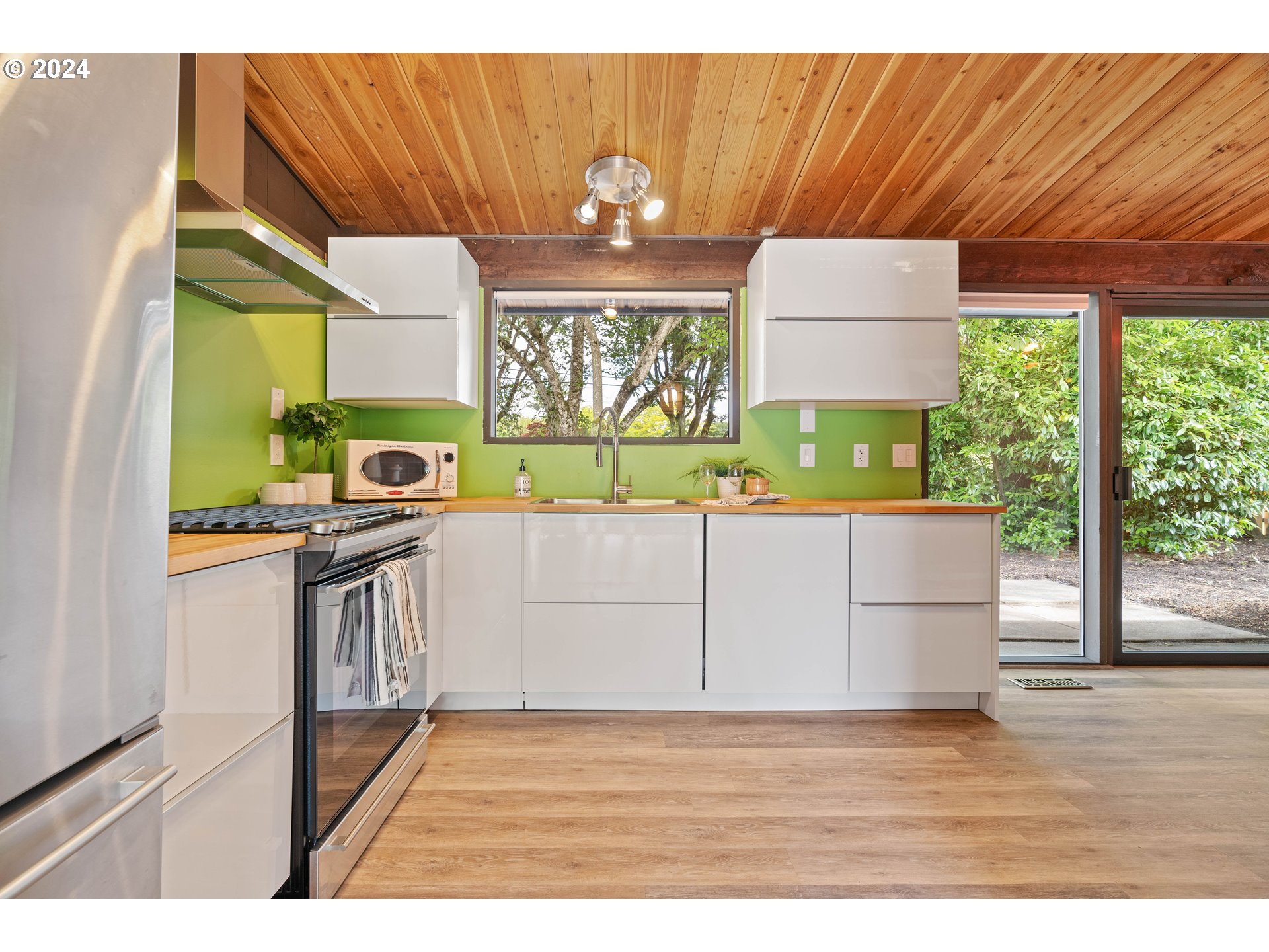 12325 Southwest Park Way Portland, OR 97225 - Photo 9 of 40 a kitchen with stainless steel appliances wooden cabinets and a large window