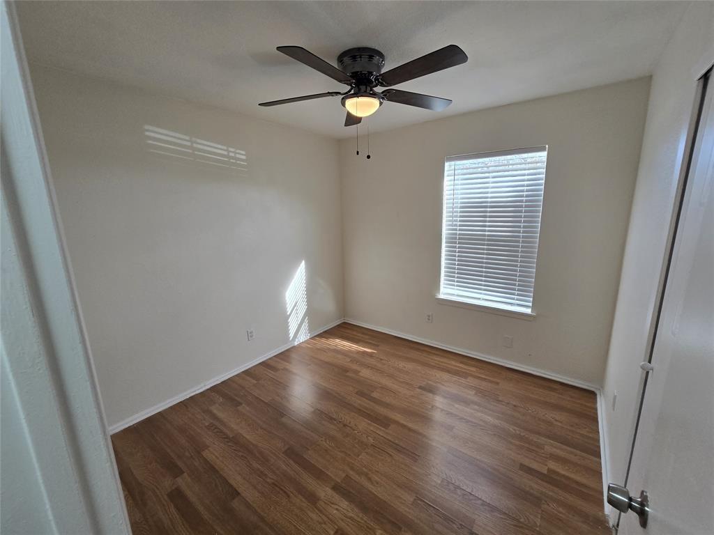 3304 Crestforest Circle Plano, TX 75074 - Photo 11 of 14 a view of an empty room with wooden floor and a window