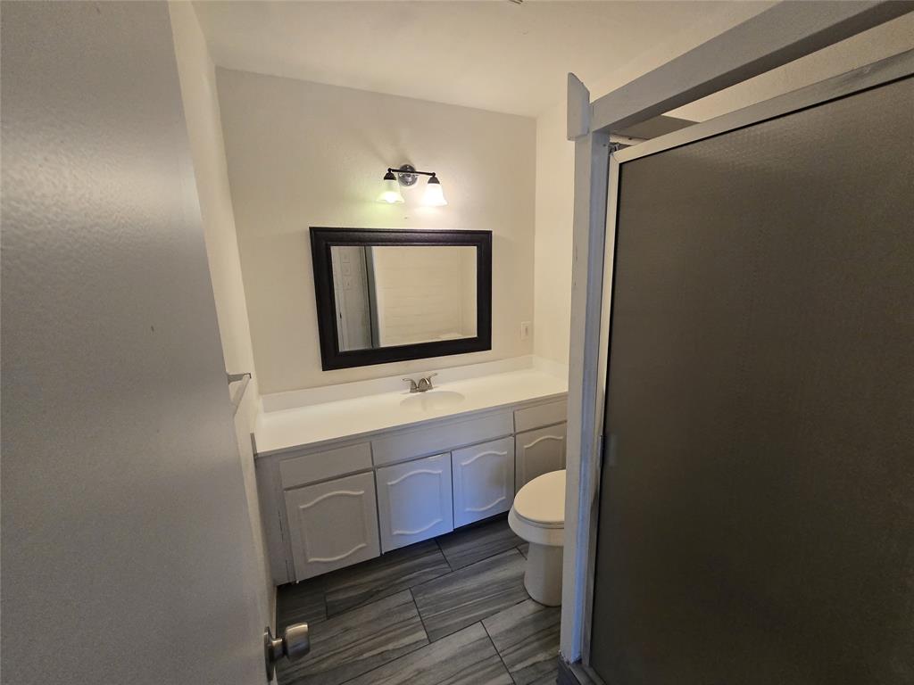 3304 Crestforest Circle Plano, TX 75074 - Photo 9 of 14 a bathroom with a toilet sink and mirror