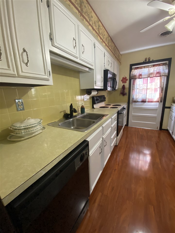 1770 Shutterlee Mill Road Staunton, VA 24401 - Photo 8 of 38 a kitchen with stainless steel appliances a sink dishwasher stove refrigerator and cabinets