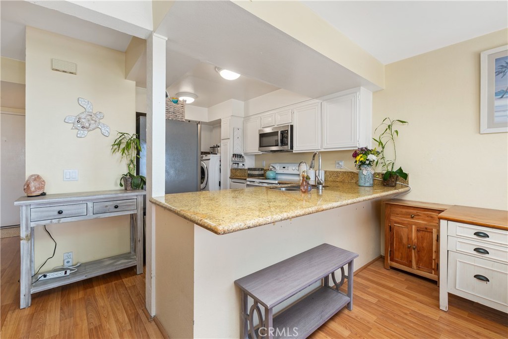 567 Avenida Adobe San Clemente, CA 92672 - Photo 12 of 33 a kitchen with stainless steel appliances granite countertop a sink a stove a refrigerator and cabinets